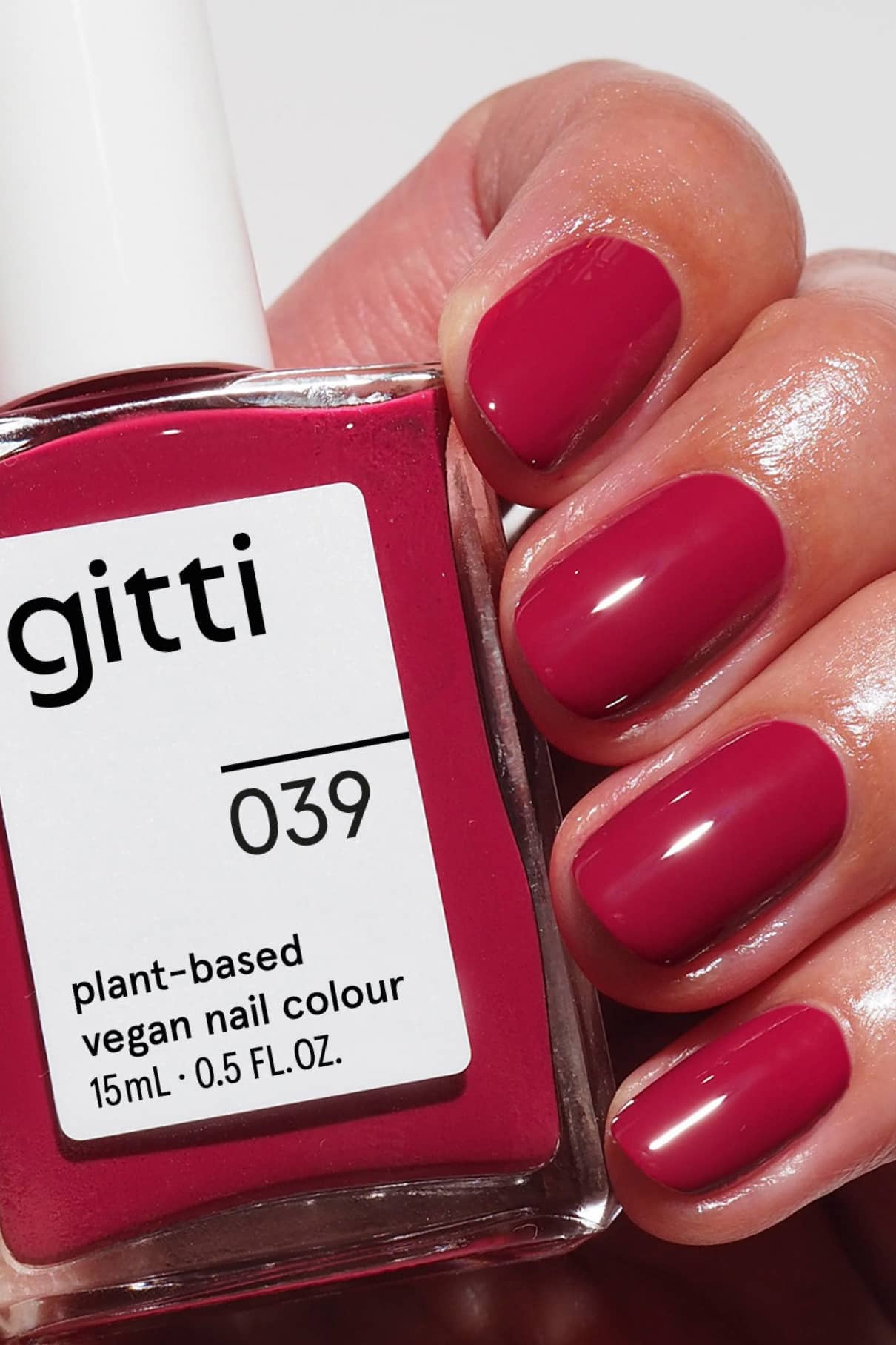 gitti vegan nail polish with a hand wearing red nails