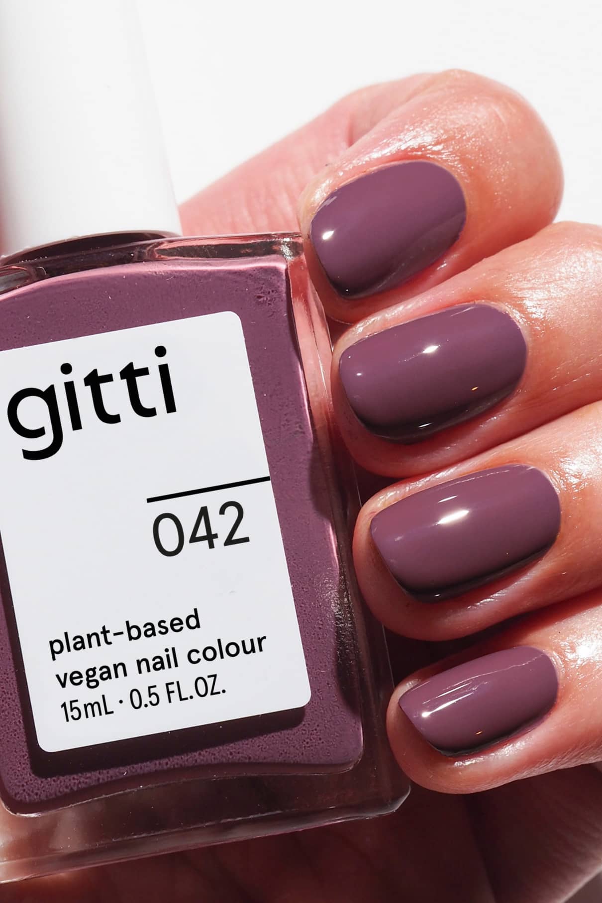 gitti plant-based vegan nail polish with a hand displaying purple nails.