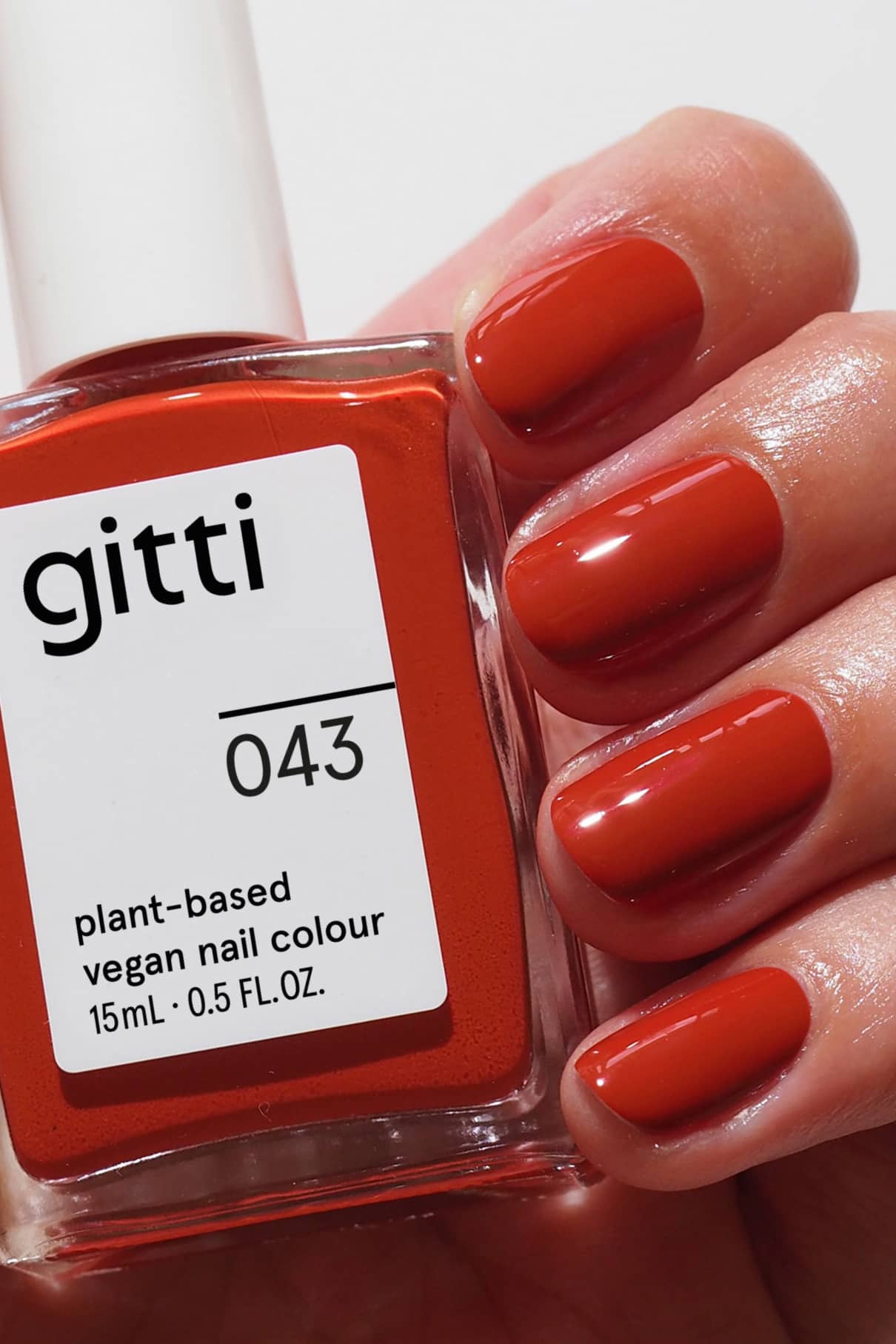 gitti nail polish bottle and matching red nails